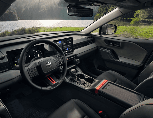 2026 RAV4 Plug-in Hybrid Woodland trim interior design with orange stitching
