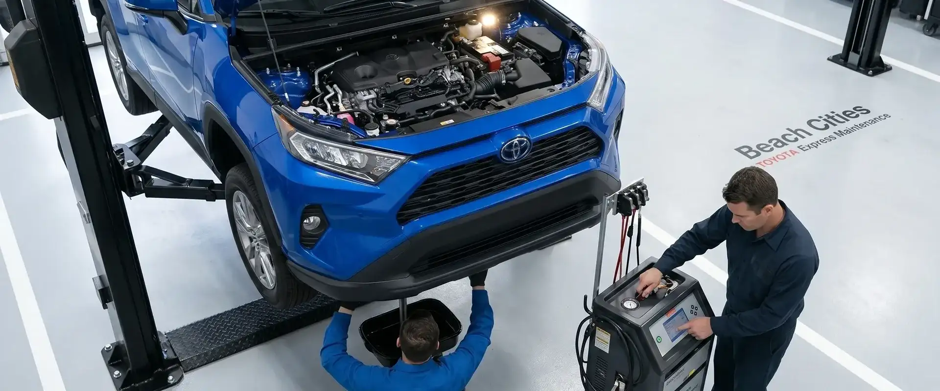 Toyota factory-scheduled maintenance technician servicing vehicle
