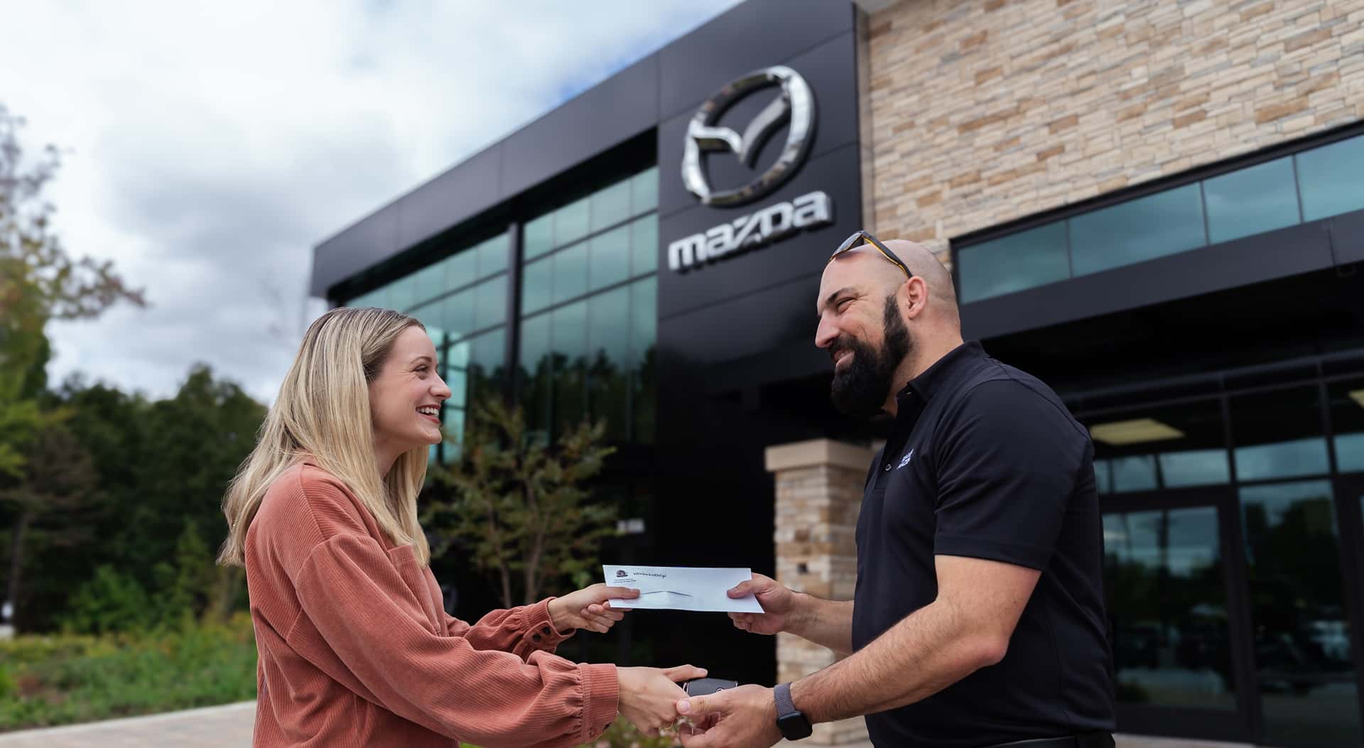 Beaver Mazda employee shaking hands with customer
