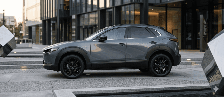 Mazda CX-30 parked outside modern office building