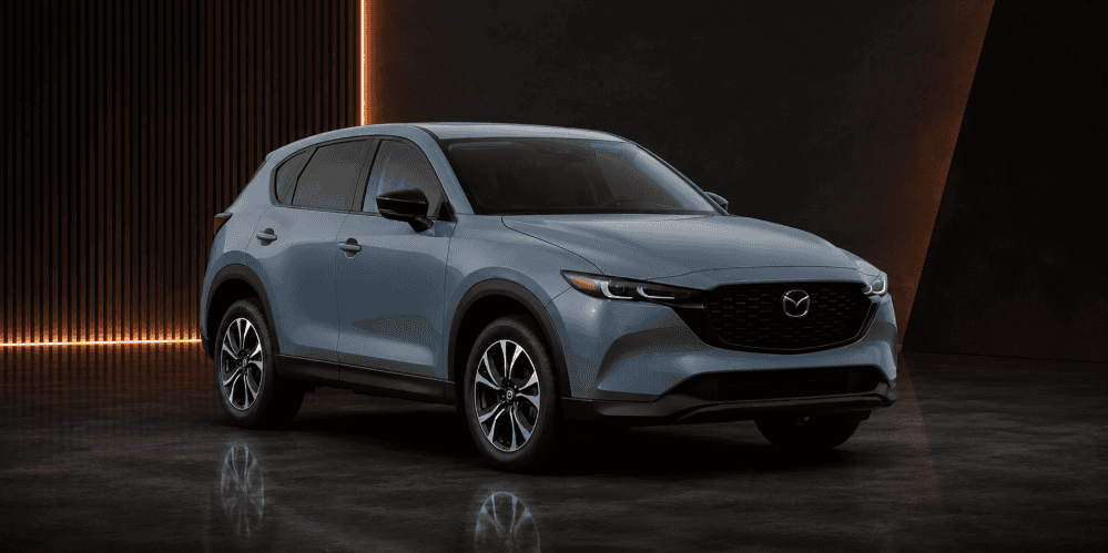 2026 Mazda CX-5 crossover SUV in blue-gray studio setting