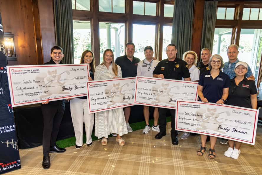 Beaver Toyota and Mazda team members presenting donation checks to local charities