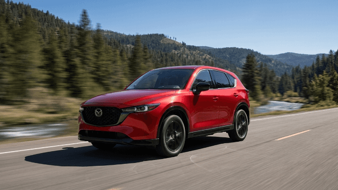 Red Mazda CX-5 driving down a scenic mountain highway near Buford, GA