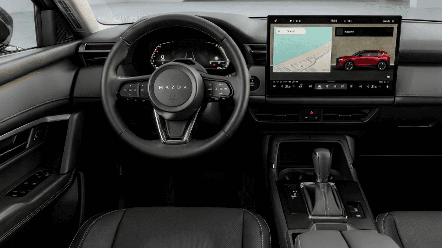 Mazda CX-5 dashboard with large infotainment screen showing a navigation map