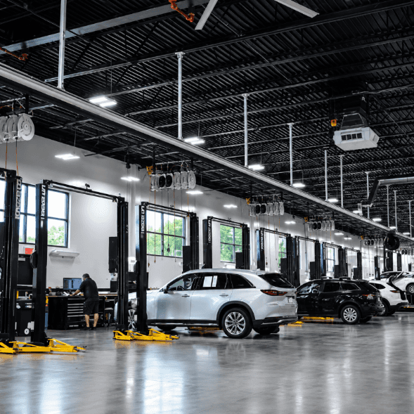Beaver Mazda service center in Cumming, GA with vehicles undergoing maintenance in professional service bays
