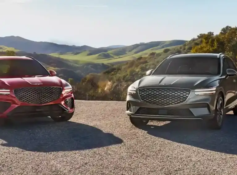 2026 Genesis GV70 SUV exterior shot in luxury showroom setting - 2026 Genesis GV70 SUV
