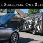 Benzel-Busch Mobile Service Unit van parked in a residential driveway next to a Mercedes-Benz with its hood open, with the headline 'Your Schedule. Our Service