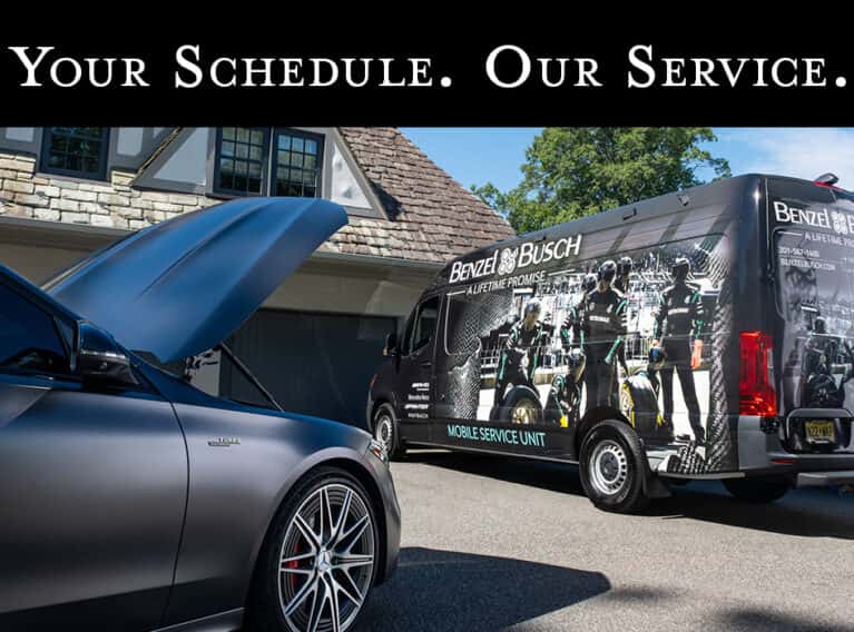 Benzel-Busch Mobile Service Unit van parked in a residential driveway next to a Mercedes-Benz with its hood open, with the headline 'Your Schedule. Our Service