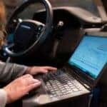 car buyer analyzing vehicle pricing details on a smartphone