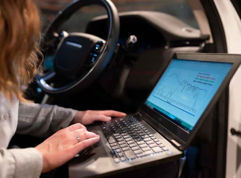 car buyer analyzing vehicle pricing details on a smartphone