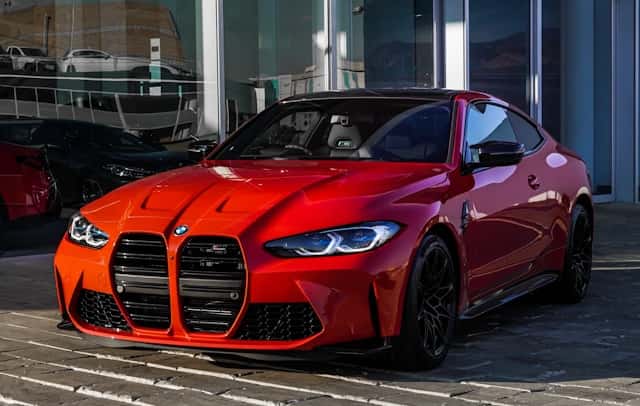 Red bmw m 3 coupe parked on gray concrete pavement during daytime