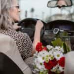 A Woman in Leopard Print Top Driving a Car
