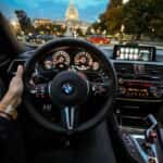 Person Holding Bmw Steering Wheel