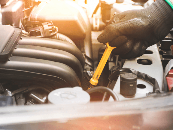 person checking and changing Subaru car oil