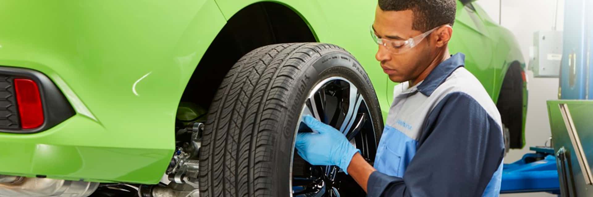 honda service technician working on tire