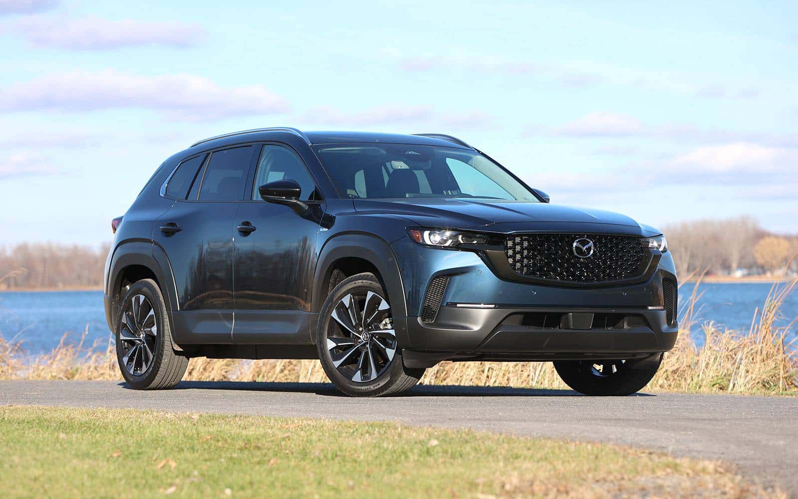 2026 Mazda CX-50 Hybrid in Polymetal Gray parked by a lake