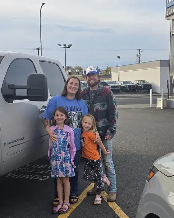Customers with their new truck at a Bud Clary store