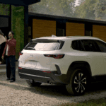 Mazda CX-50 parked outside modern home with family