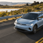 2026 Volkswagen ID.4 driving on scenic lakeside road