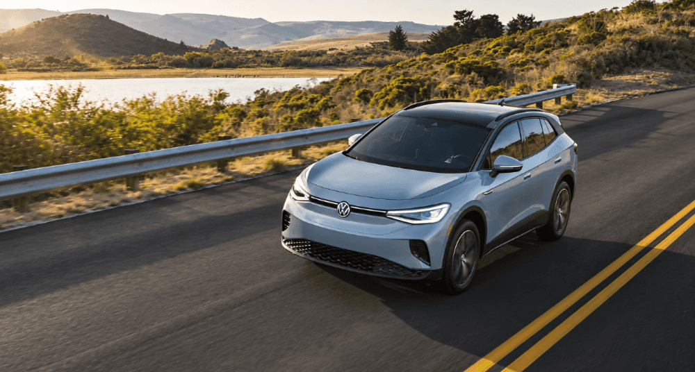 2026 Volkswagen ID.4 driving on scenic lakeside road