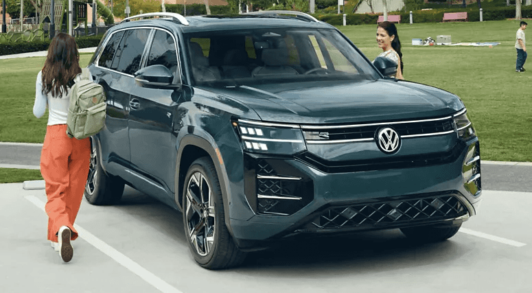 2027 Volkswagen Atlas parked beside a park as passengers approach