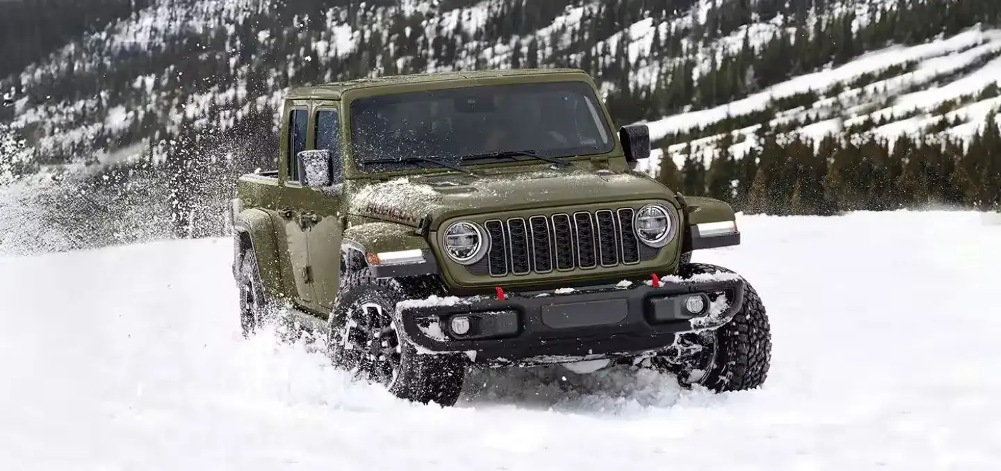 Jeep Gladiator towing a trailer in the snow