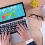 credit score on laptop researching