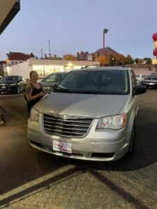 customer next to their new mini van at carhop of appleton