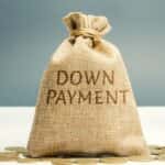 brown bag full of money that reads the words "down payment"