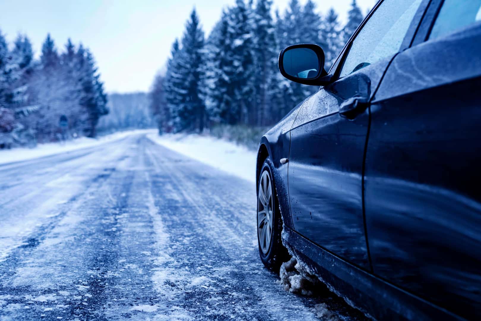 Car driving on a snowy winter road
