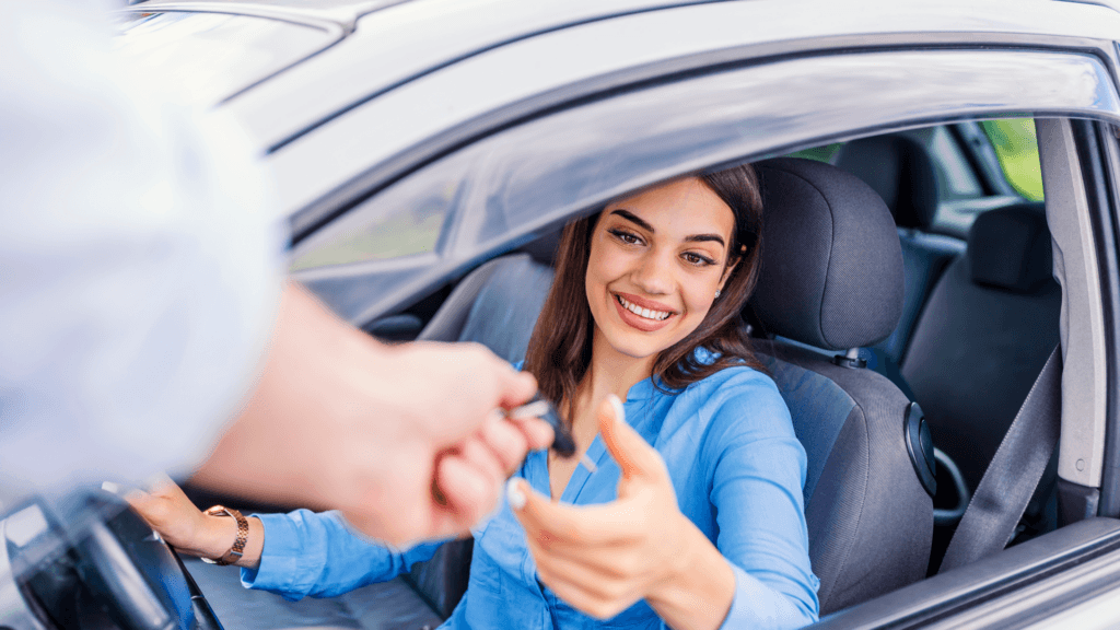 customer getting keys handed to them at a dealership