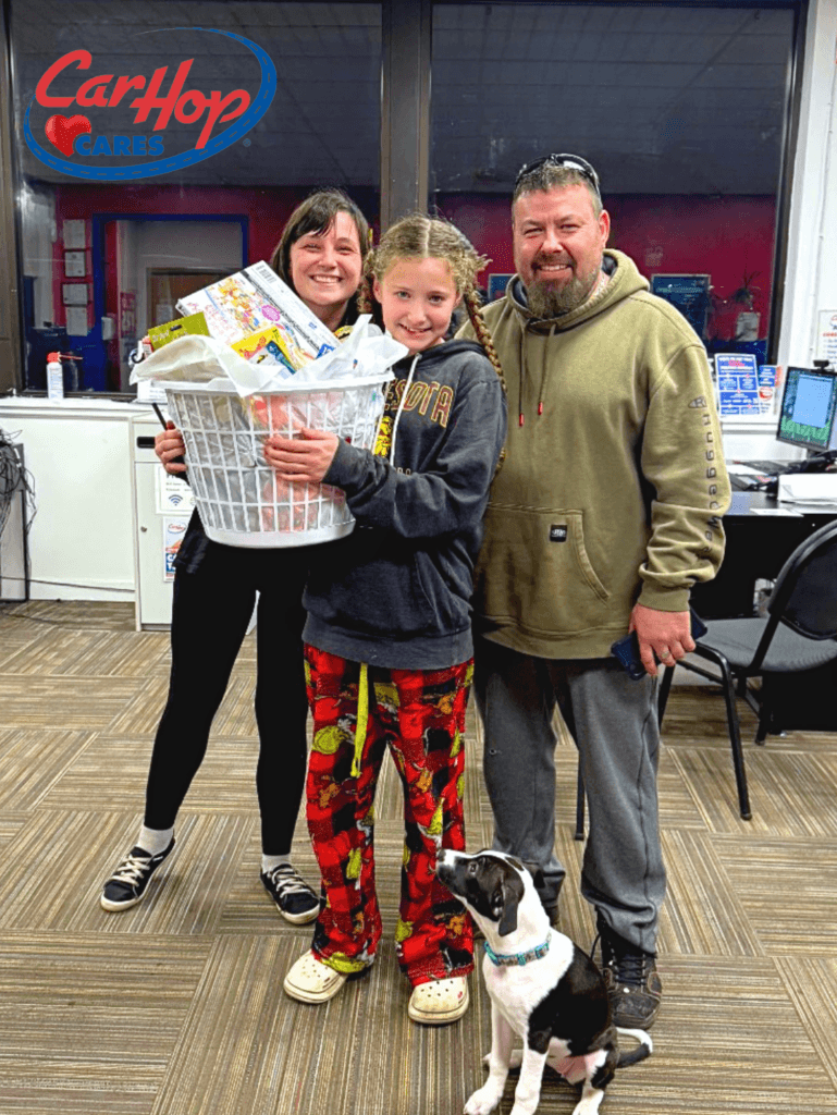 Customers of CarHop of Duluth holding their baskets filled with essential household supplies like paper towels and other necessities.