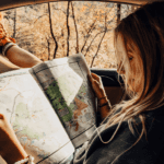girl with map open in car
