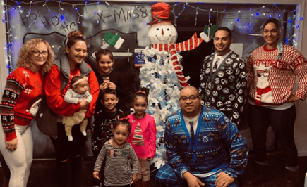 the carhop team posing with their families during christmas time