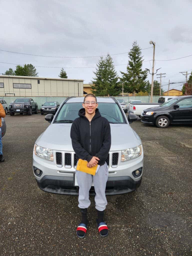 carhop of everett washington customer infront of their new SUV