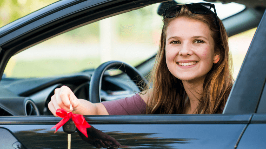 Girl with car keys at dealership