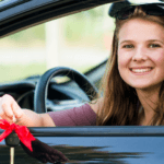 Girl with car keys at dealership