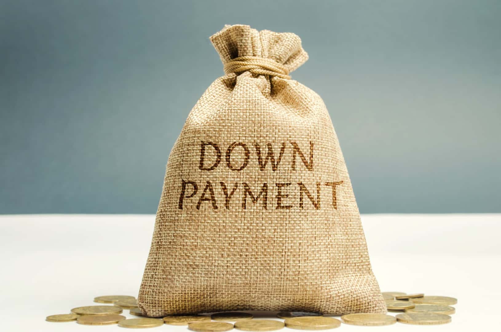brown bag full of money that reads the words "down payment"