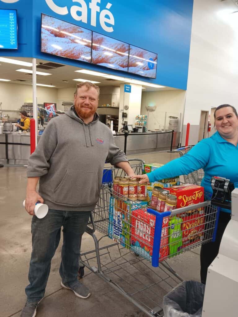 Customers of CarHop of Sioux City happily holding their food baskets, filled with a variety of delicious and essential meal items.