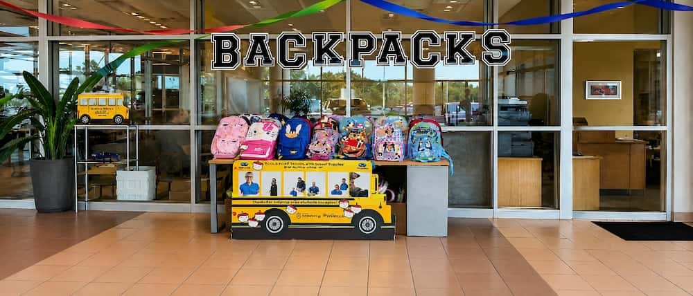 Backpacks and school supplies displayed for the Cars and Cuts back-to-school event in McHenry