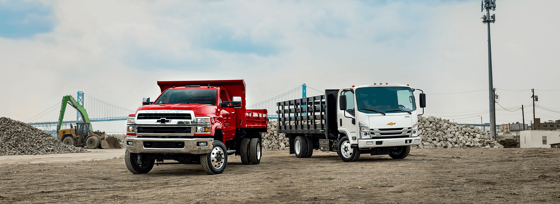 Two Chevrolet heavy duty commercial vehicles on a jobsite. Castle Chevrolet North is your premier Chevy Commercial and Fleet Vehicle dealer in the Chicagoland area.