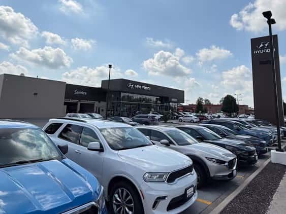 Storefront from sidewalk with row of Used Cars in Front at Castle Hyundai of Oak Lawn