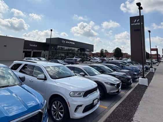 Storefront from sidewalk with row of Used Cars in Front at Castle Hyundai of Oak Lawn