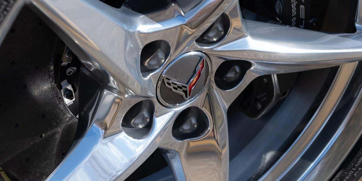 Close-up of a 2025 Chevrolet Corvette E-Ray chrome wheel with the Corvette emblem, showcasing its premium design and performance. Available at Castle Rock Chevy.