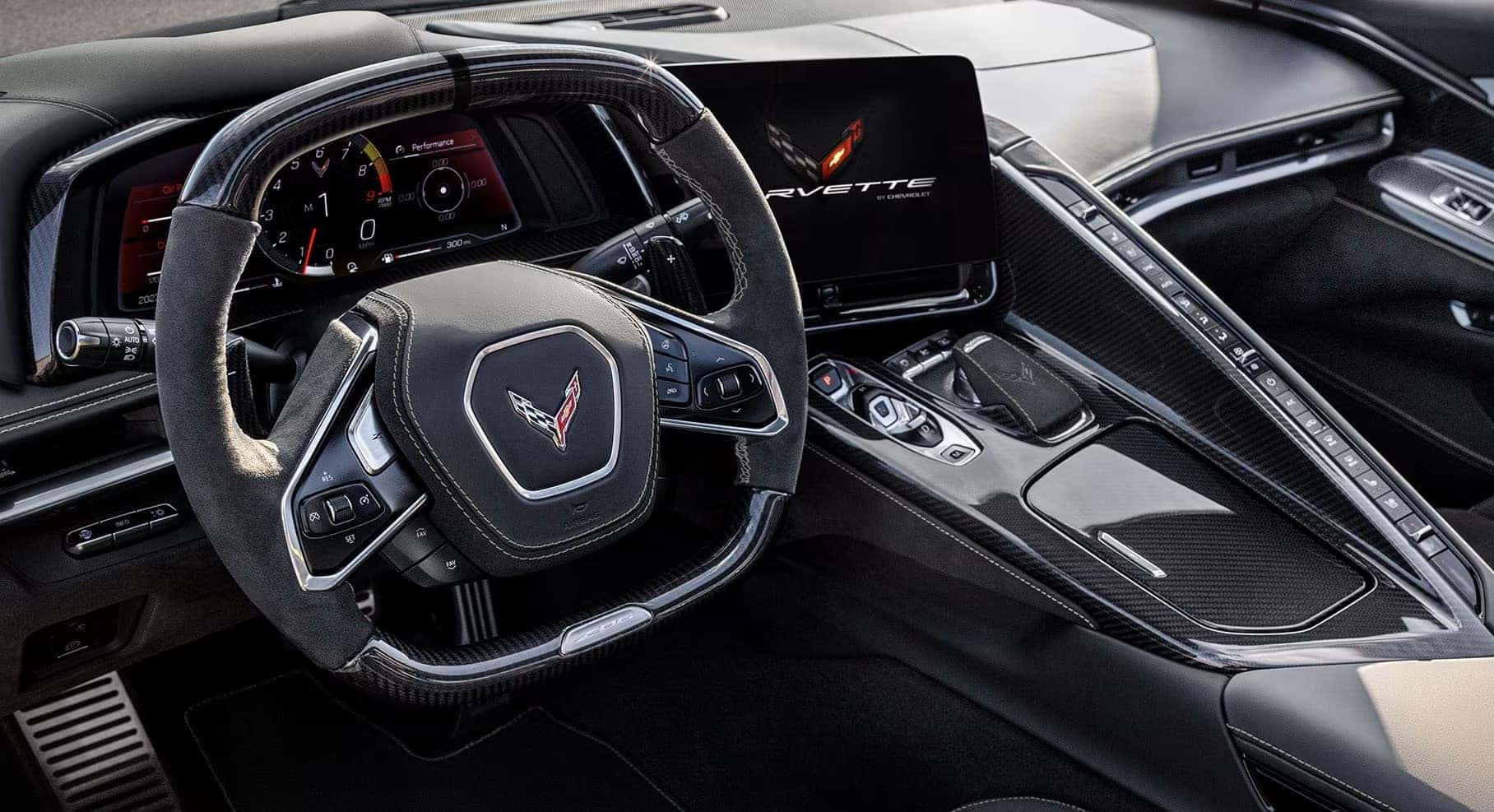 2025 Corvette Z06 interior with carbon fiber trim, digital display, and flat-bottom steering wheel.