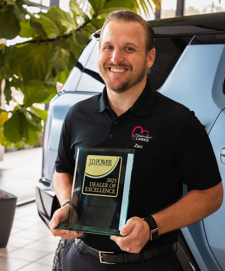 General Manager Zac holding the J.D. Power award trophy at Cavender Buick GMC North