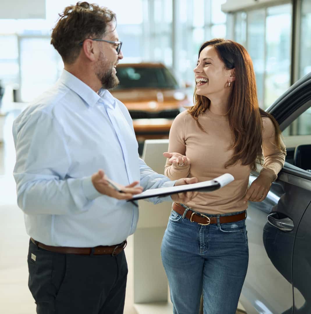 Dealership employee talking with a woman