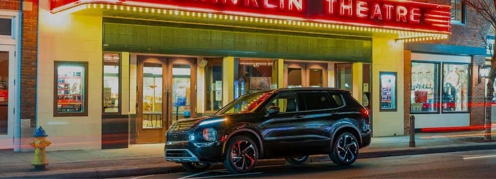 Mitsubishi vehicle in front of a theater