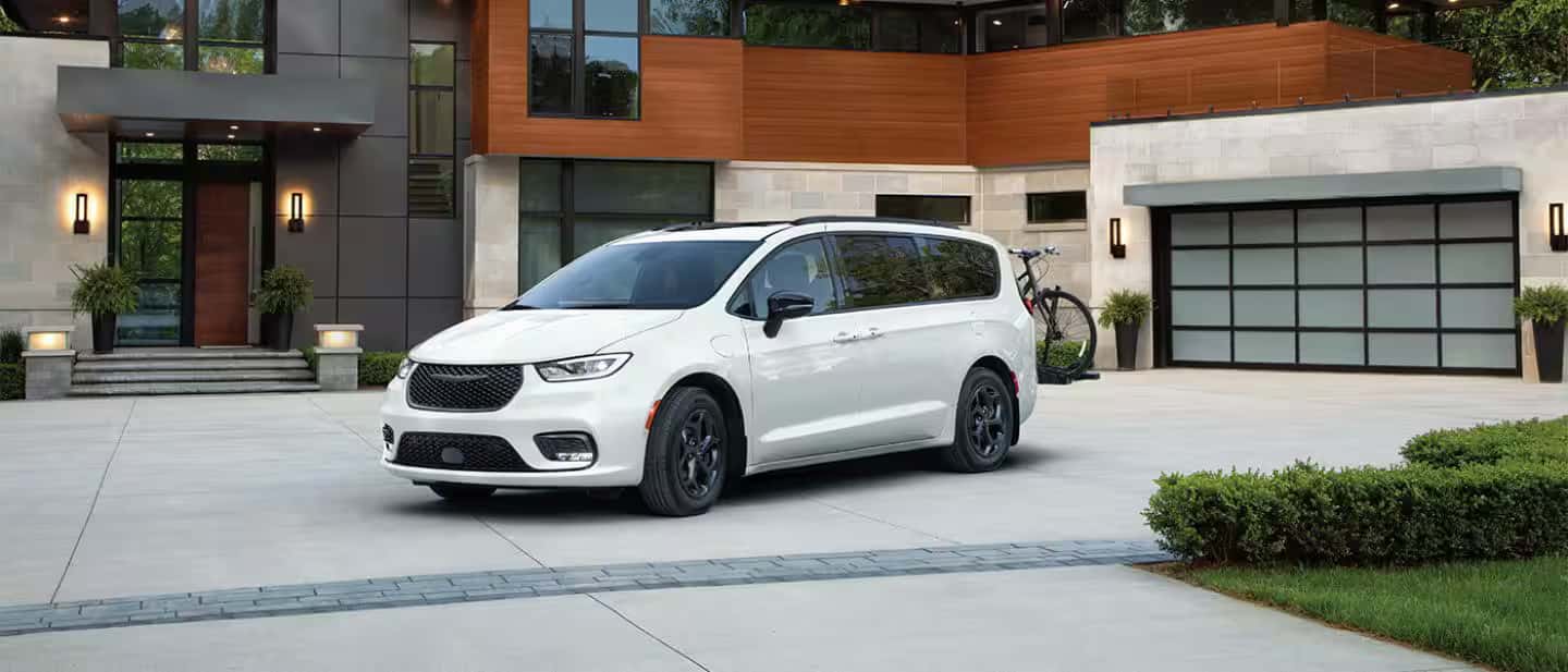 2026 Chrysler Pacifica Plug-In Hybrid parked outside of nice house