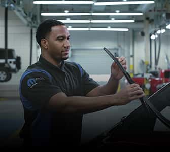 service man working on windshield wipers